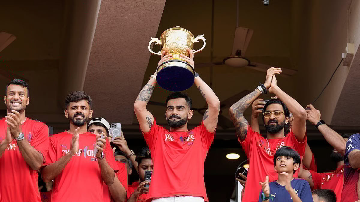 Royal Challengers Bengaluru's Virat Kohli displays the Indian Premier League winners' trophy to the fans at the M. Chinnaswamy Stadium in Bengaluru. - File/AP