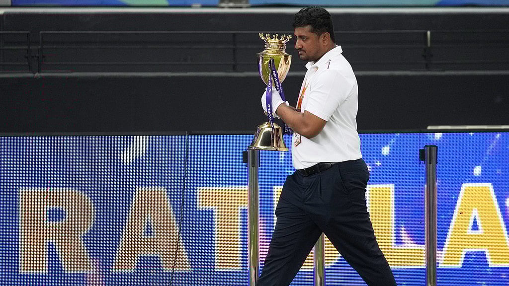 AP : An official removes the winners' trophy from the presentation area after India won the Asia Cup cricket final against Pakistan at Dubai International Cricket Stadium.