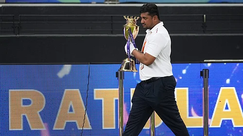AP : An official removes the winners' trophy from the presentation area after India won the Asia Cup cricket final against Pakistan at Dubai International Cricket Stadium.