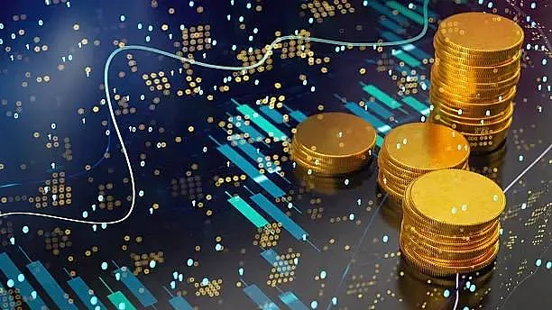 Stacks of gold coins on digital financial chart background