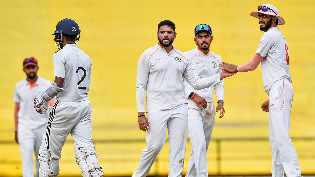 PTI : Vidarbha's Parth Rekhade, centre, celebrates with teammates after taking the wicket of Rest of India's Abhimanyu Easwaran on day two of the Irani Cup match.