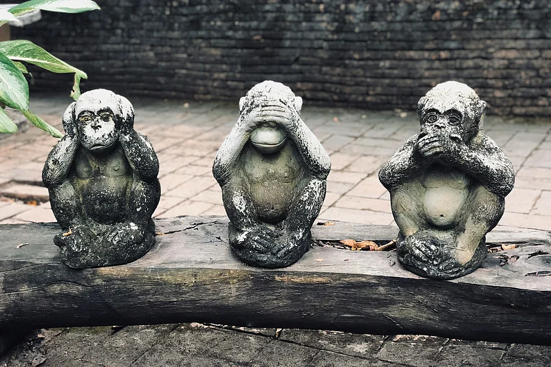 Three wise monkeys statues