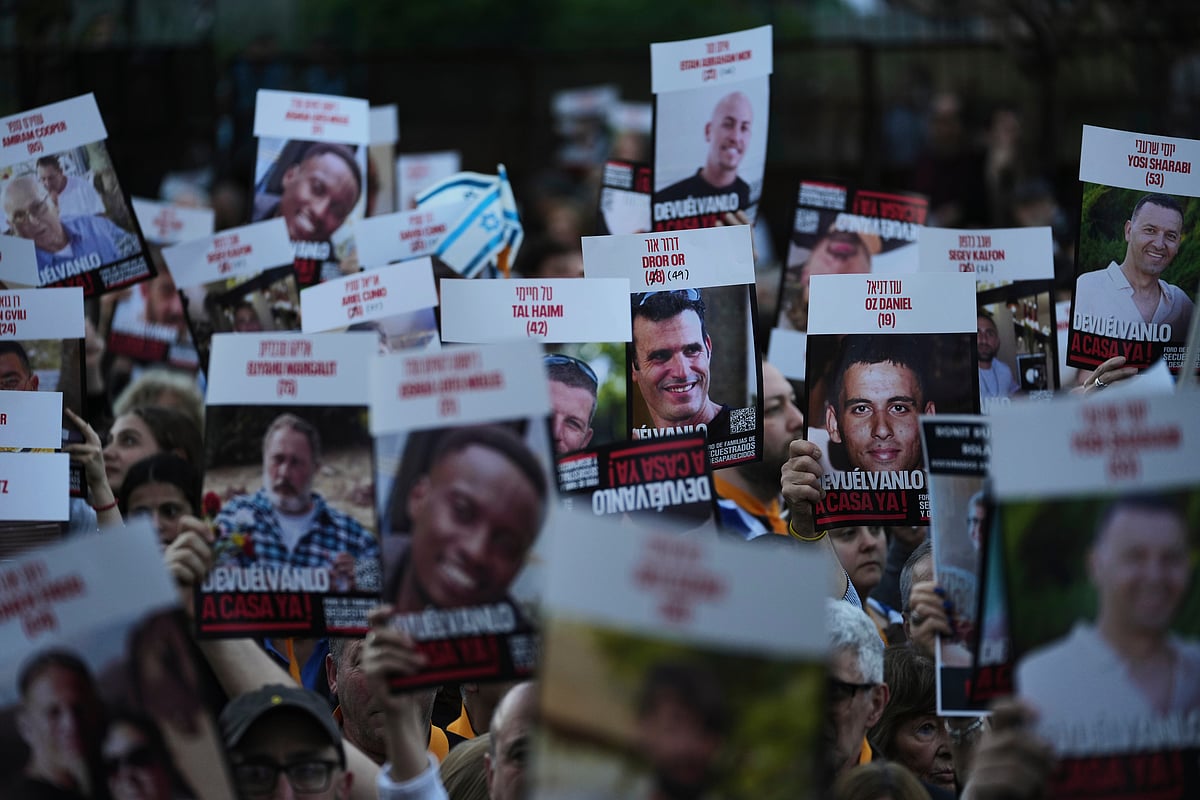People hold up posters of hostages in Hamas captivity in Gaza, to demand their release, in Buenos Aires, Argentina, Tuesday, Sept. 30, 2025. - AP Photo/Rodrigo Abd
