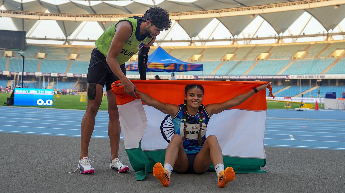 PTI : Simran Sharma, right, celebrates her medal in the women's 200m T12 final with guide Saifi Umar during the World Para Athletics Championships 2025, at Jawaharlal Nehru Stadium.