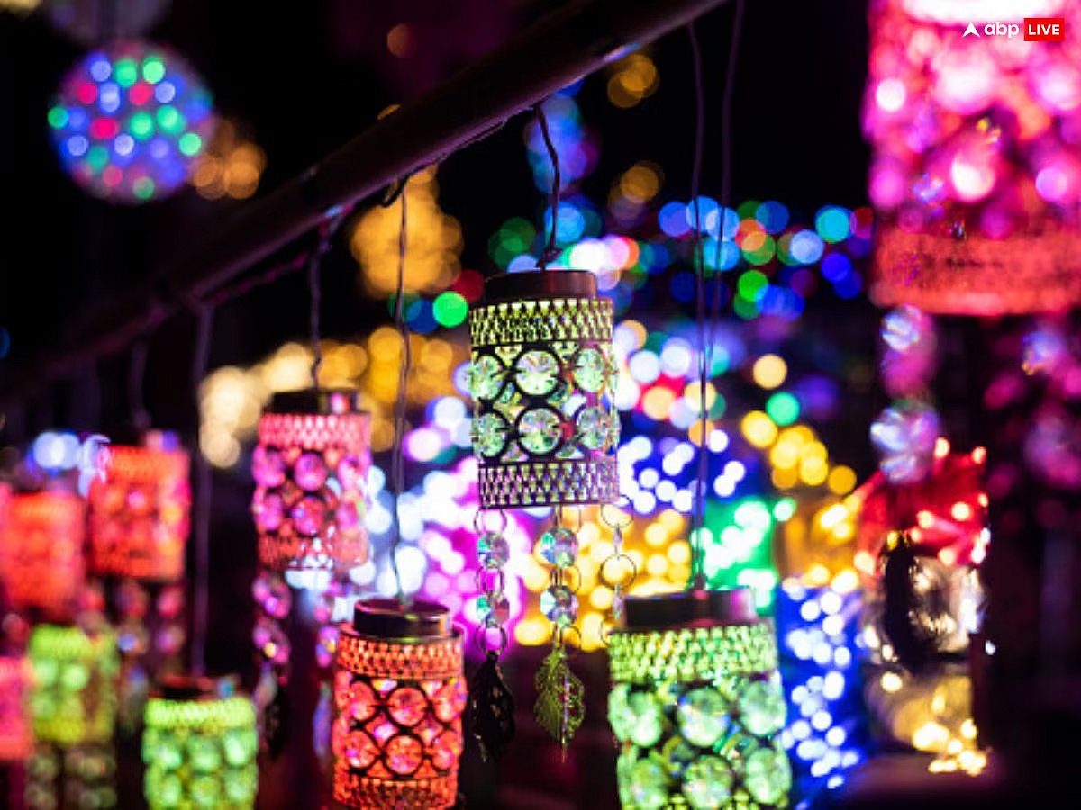 Colorful, glowing cylindrical lanterns and bright bokeh lights at night, likely for a festival.
