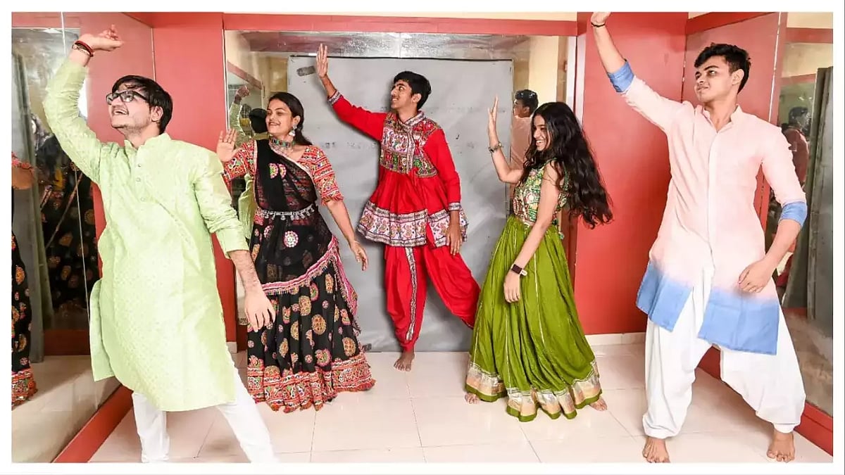 Five people in traditional Indian clothing posing for a Bollywood Dance Off.