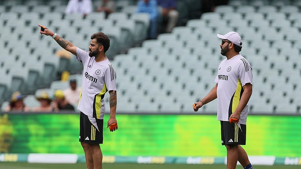 | Photo: AP/James Elsby : Rohit Sharma, right, and teammate Virat Kohli train