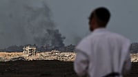 Israel Conducts Air Strikes On Southern Gaza After Clashes With Hamas Fighters (AP Photo/Ariel Schalit) : A Jewish man observes smoke rising to the sky after an explosion in the Gaza Strip, as seen from southern Israel, Thursday, Oct. 9, 2025, following the announcement that Israel and Hamas have agreed to the first phase of a peace plan to pause the fighting.