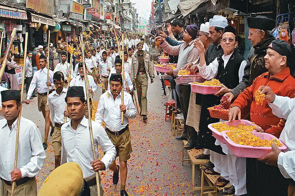 | Photo: PTI : Muslim-Hindu: Muslims shower flowers on RSS cadres outside the shrine of Sufi Saint Khwaja Moinuddin Chisti in Ajmer 
on October 3, 2013