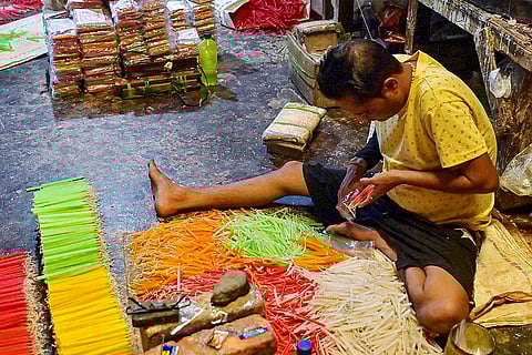 Workers prepare candles ahead of Diwali