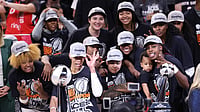 A'ja Wilson #22 of the Las Vegas Aces holds the championship trophy and poses with teammates after winning game four of the 2025 WNBA Playoffs finals at Mortgage Matchup Center on October 10, 2025 in Phoenix, Arizona. The Las Vegas Aces defeat the Phoenix Mercury 97-86 to win the championship.
