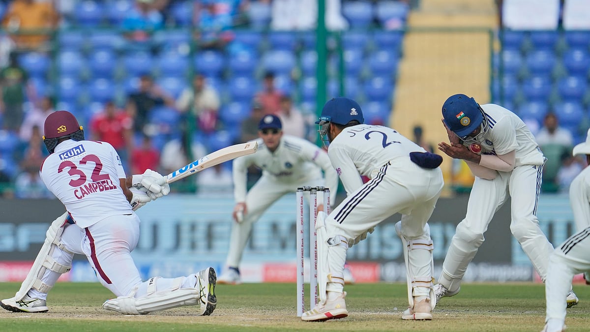 (AP Photo/Manish Swarup) : India's Sai Sudharsan, right, reacts in pain after taking the catch of West Indies' John Campbell, left, hurting his little finger on the second day of the second cricket test match between India and West Indies at the Arun Jaitley Stadium in New Delhi, India, Saturday, Oct.11, 2025.