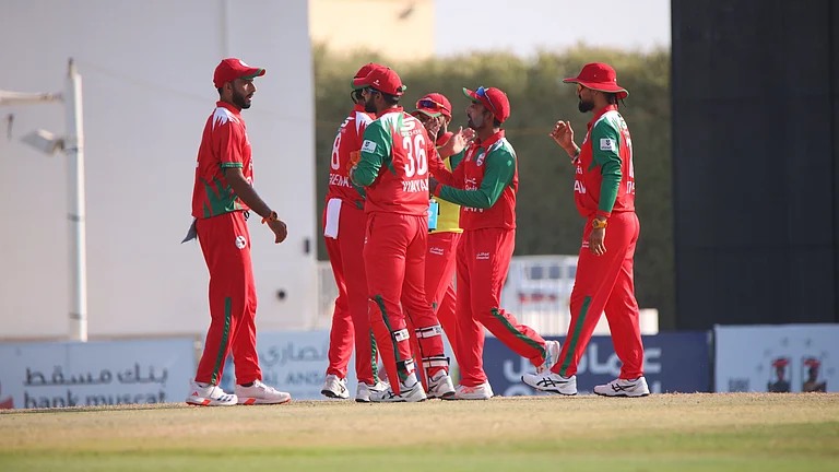 Oman players celebrate a wicket during the ICC Men's T20 World Cup Qualifier match against the UAE on October 13, 2025. - | Photo: X/EmiratesCricket