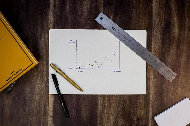 Graph showing progress with pens and ruler on a desk