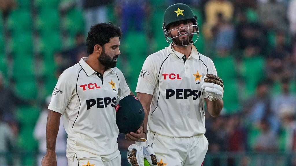 AP : Pakistan's Mohammad Rizwan, left, and Salman Ali Agha walk off at the end of play on the first day of the first Test against South Africa in Lahore.
