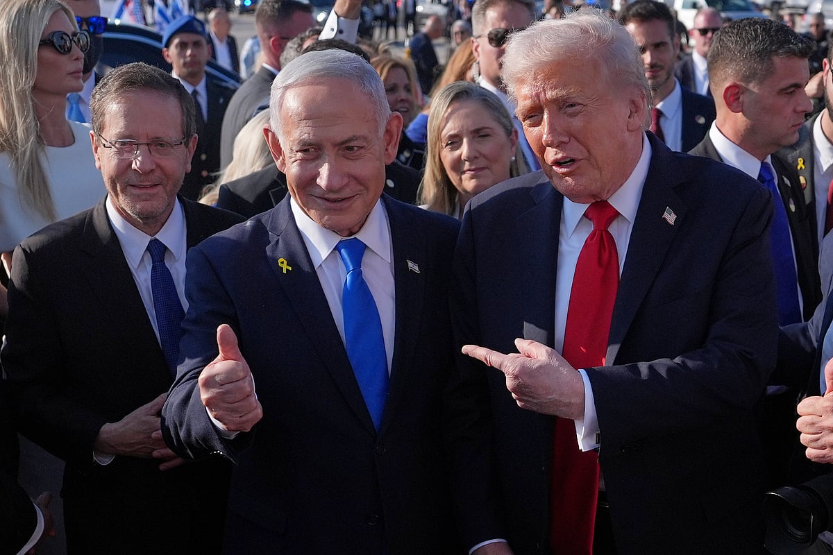 President Donald Trump poses for a photo with Israel's Prime Minister Benjamin Netanyahu before he boards Air Force One at Ben Gurion International Airport, Monday, Oct. 13, 2025, near Tel Aviv, as Israel's President Isaac Herzog watches at left - Evan Vucci