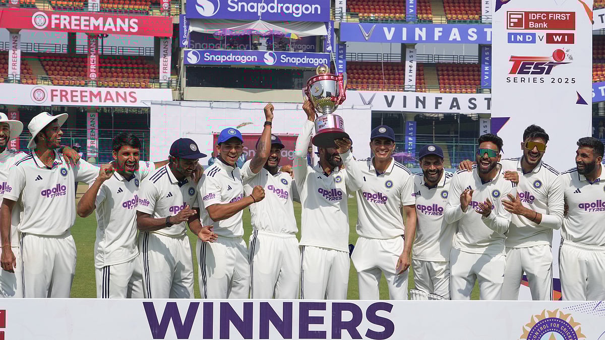 (AP Photo/Manish Swarup) : Indian players celebrate with the trophy after wining the India and West Indies test match series at the Arun Jaitley Stadium in New Delhi, India, Tuesday, Oct.14, 2025.