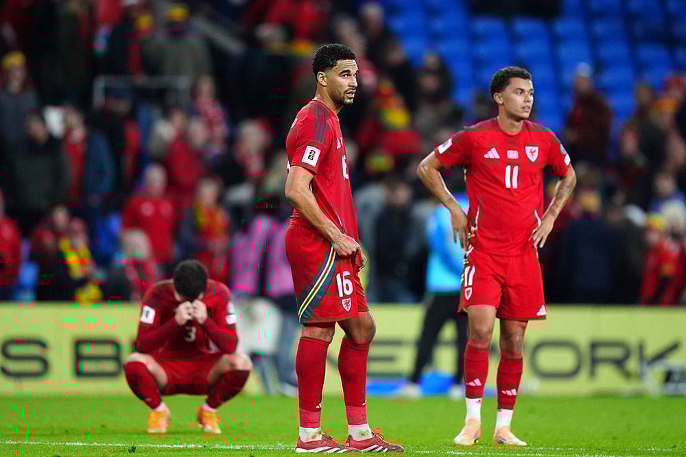 | Photo: David Davies/PA via AP : World Cup Qualifier Soccer Match: Wales vs Belgium