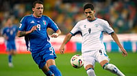 | Photo: AP/Luca Bruno : Israel's Matan Baltaxa, right, challenges for the ball with Italy's Mateo Retegui during the World Cup 2026 Group I qualifying soccer match between Italy and Israel at the Bluenergy Stadium in Udine, Italy, Tuesday, Oct. 14, 2025.