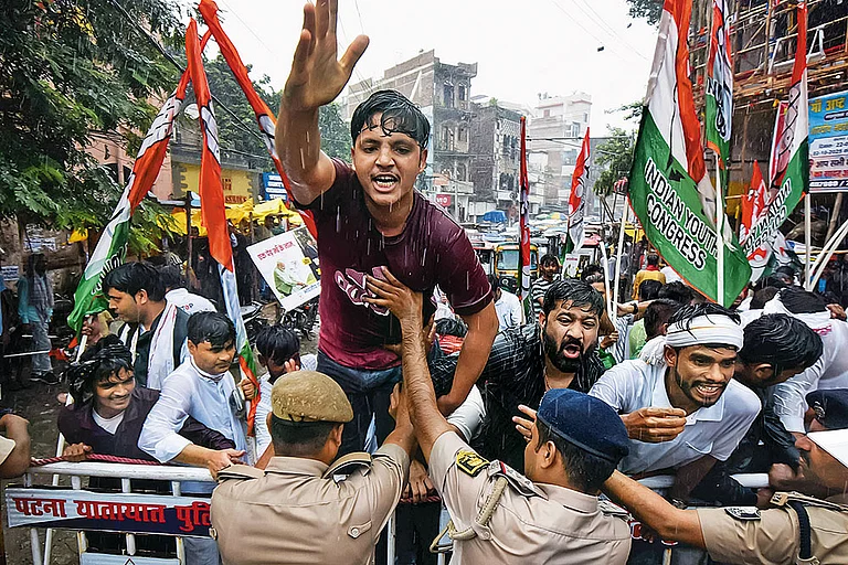 Shaping the Political Narrative: Police personnel stop Youth Congress workers during a protest in Patna on September 23.  - | Photo: Imago