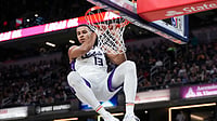 Keegan Murray #13 of the Sacramento Kings hangs on the rim after dunking the ball in the first quarter against the Indiana Pacers at Gainbridge Fieldhouse on March 31, 2025 in Indianapolis, Indiana.