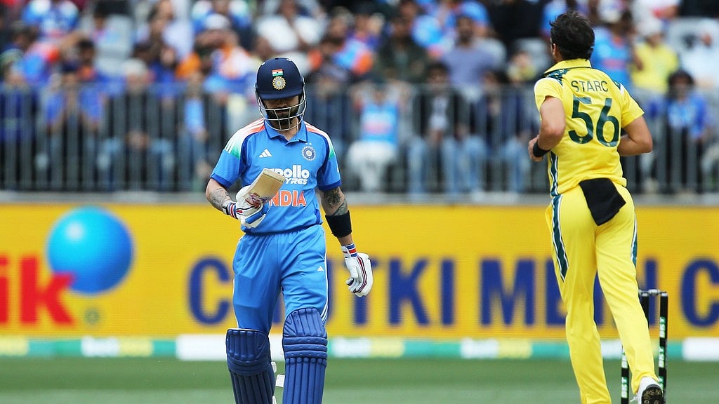 David Woodley/AAPImage via AP : Virat Kohli, left, walks off after being dismissed by Mitchell Starc during the one-day international cricket match between Australia and India in Perth.