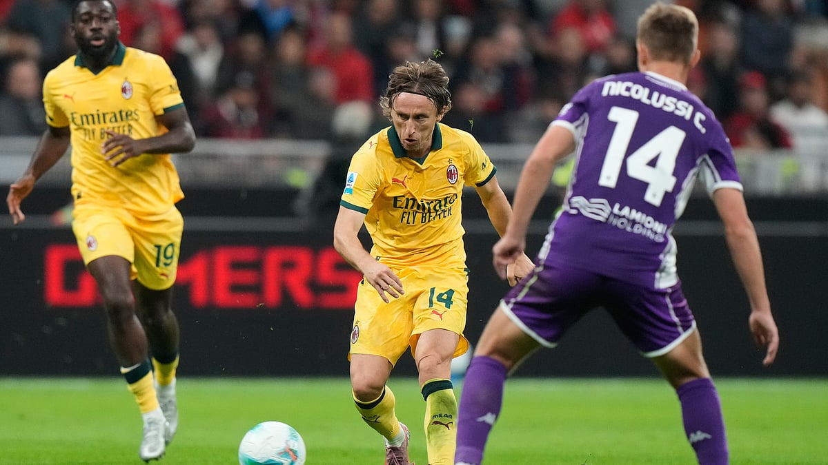 AP/Luca Bruno : Luka Modric, center, pases the ball past Fiorentina's Hans Nicolussi Caviglia during a Serie A soccer match between AC Milan and Fiorentina in Milan.