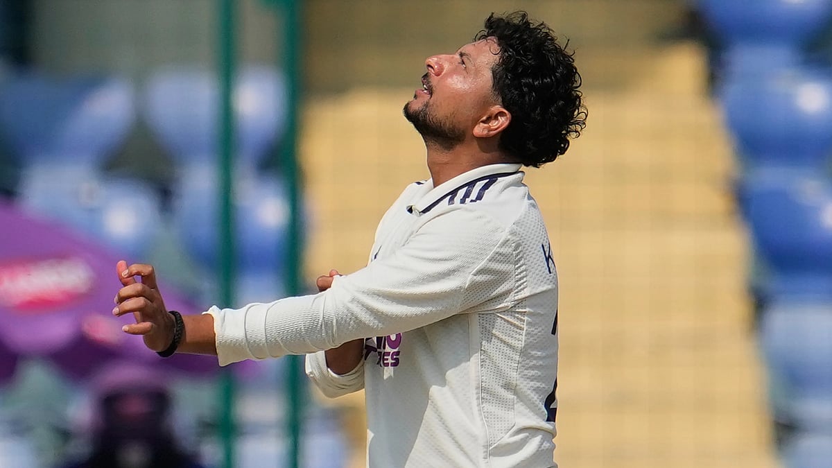 | Photo: APManish Swarup : India's Kuldeep Yadav watches as teammate Nitish Kumar Reddy takes the catch of West Indies' Khary Pierre on the fourth day of the second cricket test match between India and West Indies at the Arun Jaitley Stadium in New Delhi, India, Monday, Oct.13, 2025. 