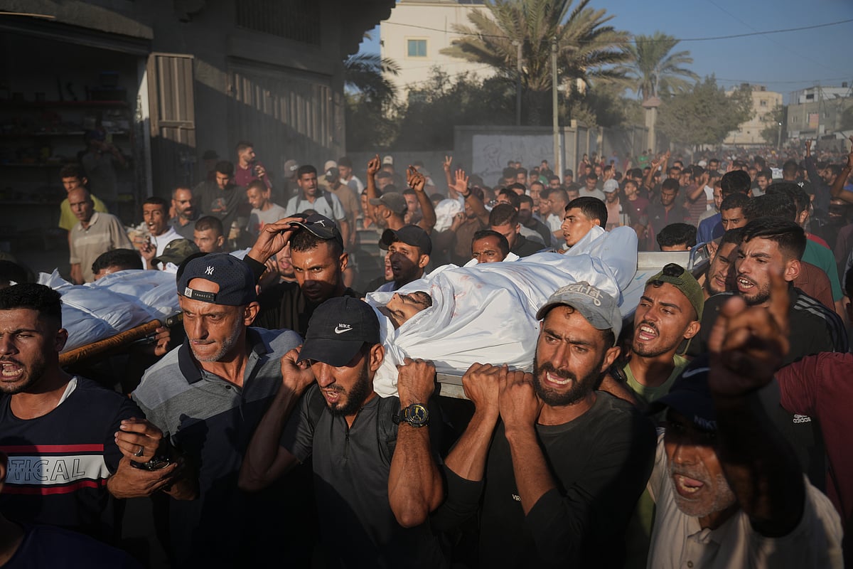 Mourners carry bodies of Palestinians killed by Israeli fire, during their funeral in Deir al-Balah, Gaza Strip, Sunday, Oct. 19, 2025.  - AP