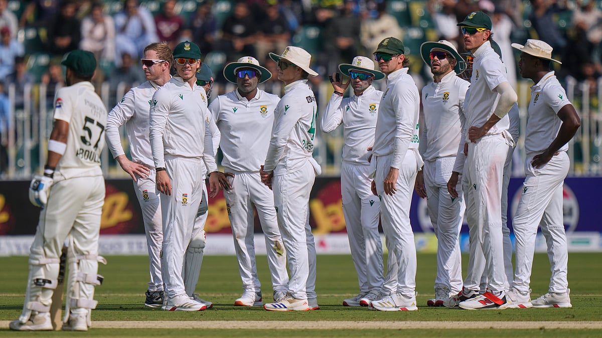 AP : Simon Harmer, second left, and teammates wait for third umpire decision regarding the dismissal of Pakistan's Abdullah Shafique, left, during the first day of the second test cricket match.