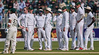 AP : Simon Harmer, second left, and teammates wait for third umpire decision regarding the dismissal of Pakistan's Abdullah Shafique, left, during the first day of the second test cricket match.