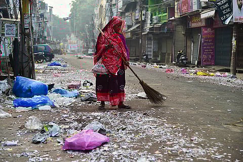 Worker cleans firecracker waste after Diwali in Prayagraj