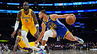 APEthan Swope : Golden State Warriors guard Stephen Curry (30) dribbles in front of Los Angeles Lakers center Deandre Ayton (5) during the first half of an NBA basketball game.