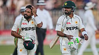 AP/Anjum Naveed : Babar Azam, right, and Mohammad Rizwan, walk off the field on the end of the play of third day of the second test cricket match between Pakistan and South Africa.