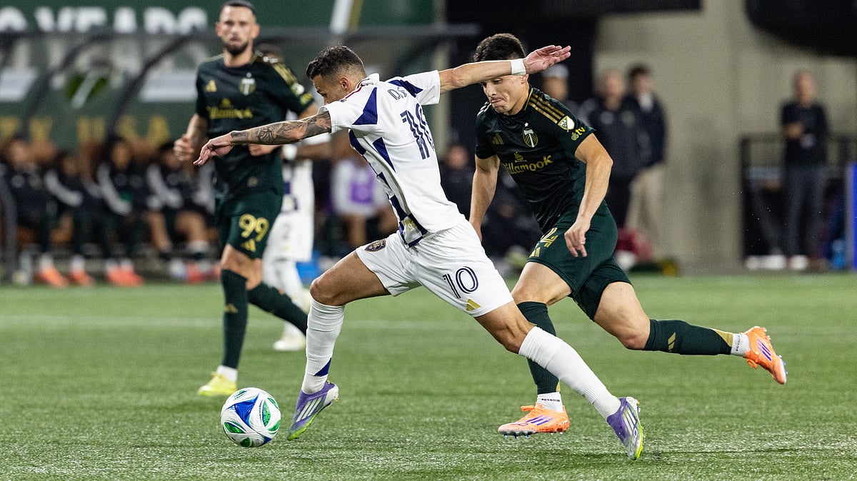 Diogo Gonçalves, middle, dribbles the ball against Portland Timbers midfielder David Ayala, right, during the first half of an MLS soccer match Wednesday. - AP/Howard Lao