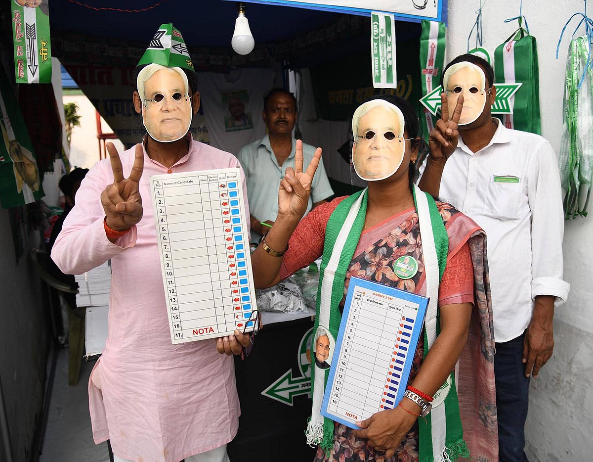 Hindustan Times : JDU supporters wearing masks of Bihar CM Nitish Kumar and holding dummy of Electronic Voting Machines (EVMs) ahead of Bihar Assembly Election 2025 at JDU office on October 14, 2025 in Patna, India. The 243-member Bihar Assembly elections are scheduled for November 6 and 11, with vote counting set for November 14
