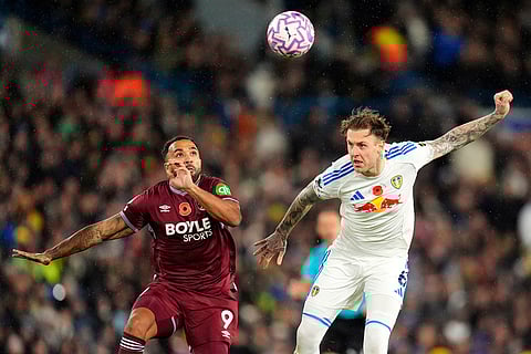 West Ham United's Callum Wilson, left, and Leeds United's Joe Rodon in action during the English Premier League soccer match between Leeds United and West Ham United at Elland Road, Leeds, England.