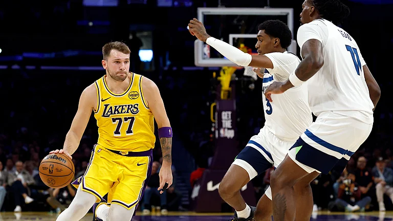 Luka Doncic #77 of the Los Angeles Lakers controls the ball against Jaden McDaniels #3 of the Minnesota Timberwolves in the first half at Crypto.com Arena on October 24, 2025 in Los Angeles, California. - null