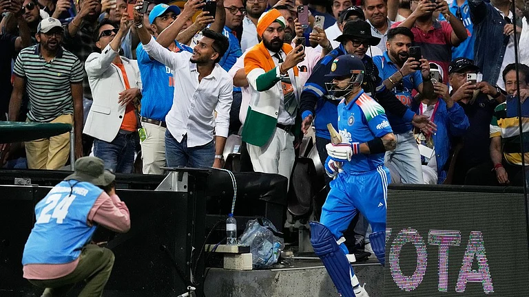 India's Virat Kohli runs out to bat against Australia during the third ODI in Sydney. - AP