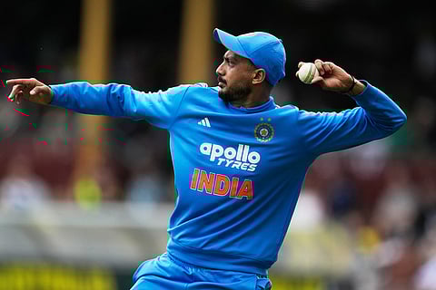 India's Axar Patel throws a ball he gathered near the boundary during their One Day International cricket match against Australia in Sydney, Australia.