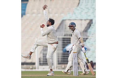 Gujarat's Siddharth Desai bowls a delivery on day one of a Ranji Trophy cricket match between Bengal and Gujarat, at the Eden Gardens, in Kolkata, West Bengal. 