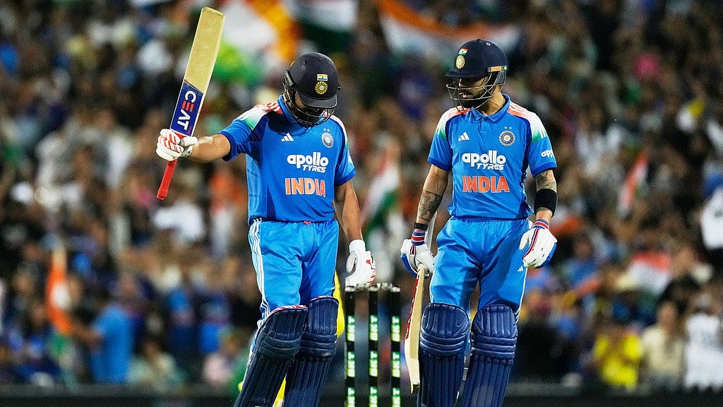 Photo: AP : India Vs Australia Highlights, 3rd ODI: Rohit Sharma, left, raises his bat after making 100 runs against Australia as teammate Virat Kohli watches on in Sydney.