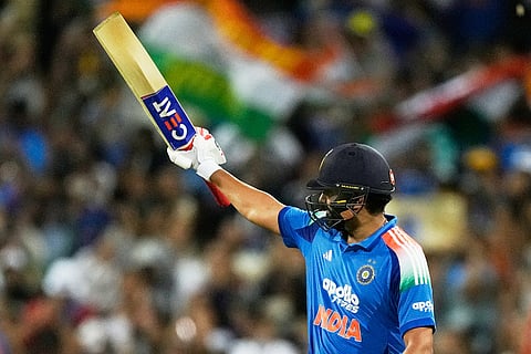 India's Rohit Sharma raises his bat after making 100 runs against Australia during their One Day International cricket match in Sydney, Australia.