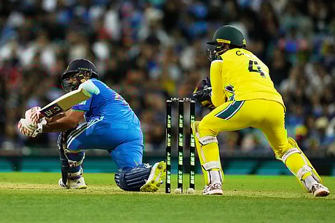 India's Rohit Sharma, left, bats in front of Australia's Alex Carey during their One Day International cricket match in Sydney, Australia.
