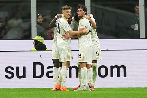 Pisa players celebrate after a goal during the Serie A soccer match between AC Milan and Pisa in Milan, Italy.