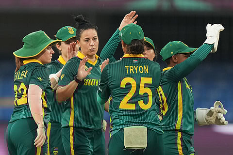 South Africa's Marizanne Kapp, center, celebrates with teammate the wicket of Australia's Phoebe Litchfield during the ICC Women's Cricket World Cup match between Australia and South Africa in Indore.