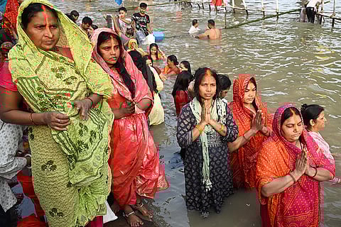 Women offer prayers while observing 'Chhath Puja' rituals on the banks of the Ganga river, in Patna.