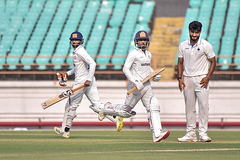 Saurashtra’s Ravindra Jadeja and Ansh Gosai run between the wickets on day one of a Ranji Trophy cricket match between Saurashtra and Madhya Pradesh, at Niranjan Shah Stadium, in Rajkot.