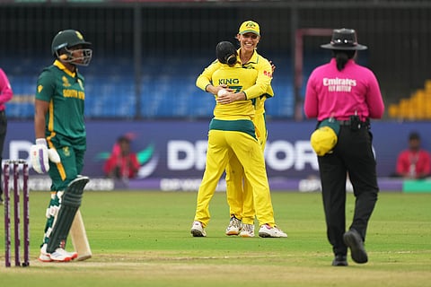 Australia's Alana King, center, celebrates with teammate the wicket of South Africa's Chole Tryon during the ICC Women's Cricket World Cup match between Australia and South Africa in Indore.
