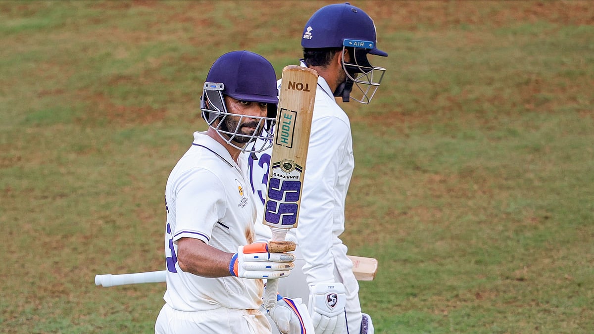 Mumbai's Ajinkya Rahane celebrates his century on day one of the Ranji Trophy match between Mumbai and Chhattisgarh, at the Sharad Pawar Cricket Academy in Mumbai. - PTI